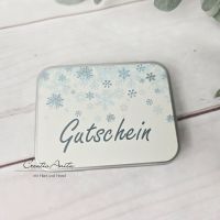 Gutscheinverpackung zu Weihnachten mit Schneeflocken